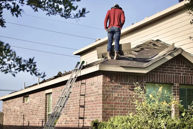 Professional roofer working on a residential roof in East of Smith Park